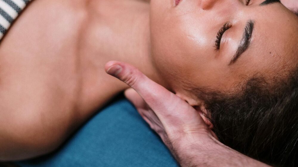 Person receiving a relaxing massage on a patterned massage table.